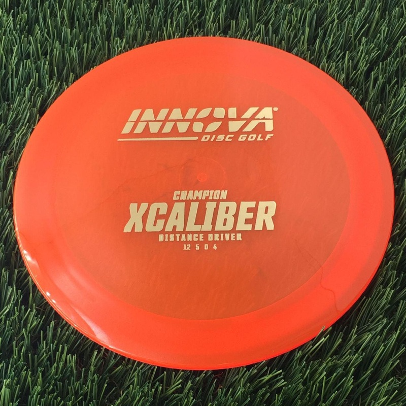 Innova Champion Xcaliber with Burst Logo Stock Stamp – 175g – Translucent Orange