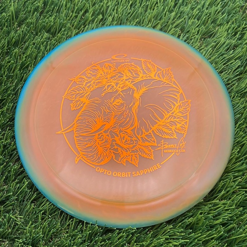 Latitude 64 Opto Ice Orbit Sapphire with Rebecca Cox Team Series 2025 Stamp – 162.35g – Teal Orange